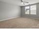 Spacious bedroom with neutral carpeting, ceiling fan, and plenty of natural light at 1660 Beleek Ridge Ln, Lake Wylie, SC 29710