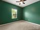 Cozy bedroom with carpeted floors, a window, and a ceiling fan at 1660 Beleek Ridge Ln, Lake Wylie, SC 29710