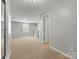 Bright bonus room with neutral carpeting, a window, and access to other rooms at 1660 Beleek Ridge Ln, Lake Wylie, SC 29710