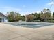 Large community pool with secured cover, tables, chairs, and clubhouse in the background at 1660 Beleek Ridge Ln, Lake Wylie, SC 29710