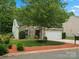 Charming brick home with a two-car garage, manicured lawn, and mature trees at 1660 Beleek Ridge Ln, Lake Wylie, SC 29710
