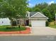 Charming brick home with well-manicured landscaping, attached two-car garage, and inviting curb appeal at 1660 Beleek Ridge Ln, Lake Wylie, SC 29710