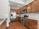 Bright kitchen with stainless appliances, granite countertops, and rich wood flooring at 1660 Beleek Ridge Ln, Lake Wylie, SC 29710