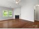 Bright living room with hardwood floors, fireplace, and large windows offering plenty of natural light at 1660 Beleek Ridge Ln, Lake Wylie, SC 29710