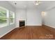 Bright and airy living room with hardwood floors, fireplace, and large windows offering great natural light at 1660 Beleek Ridge Ln, Lake Wylie, SC 29710