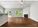 Open-concept living area with hardwood floors, fireplace, and access to the backyard via sliding door at 1660 Beleek Ridge Ln, Lake Wylie, SC 29710