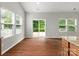Bright living room with hardwood floors and sliding doors leading to the outdoors at 1660 Beleek Ridge Ln, Lake Wylie, SC 29710