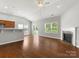 Spacious open living area with hardwood floors, fireplace, and adjacent kitchen featuring ample counter space at 1660 Beleek Ridge Ln, Lake Wylie, SC 29710