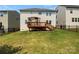Spacious backyard featuring a wooden deck with a pergola and green grass at 1680 Trentwood Dr, Fort Mill, SC 29715