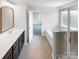 A full bathroom featuring a soaking tub, glass enclosed shower, and an adjacent bedroom view at 1680 Trentwood Dr, Fort Mill, SC 29715