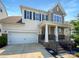 Charming two-story home with a well-maintained lawn, two-car garage, and covered front porch at 1680 Trentwood Dr, Fort Mill, SC 29715