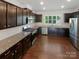 Stylish kitchen with dark wood cabinets, stainless steel appliances, and granite countertops at 1680 Trentwood Dr, Fort Mill, SC 29715