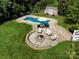 An aerial shot of a backyard featuring a pool, patio with a fire pit, and a shed at 175 Turnberry Ln, Mooresville, NC 28117