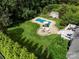 Aerial view of a home's backyard with a pool, fire pit area, and lush landscaping at 175 Turnberry Ln, Mooresville, NC 28117