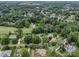 Expansive aerial view of a neighborhood surrounded by trees and a lake in the distance at 175 Turnberry Ln, Mooresville, NC 28117