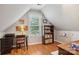 Cozy bedroom with sloped ceiling, desk, chair, bookshelf, and natural light at 175 Turnberry Ln, Mooresville, NC 28117