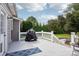 Enjoy outdoor living on a grey deck featuring covered grill and stone firepit area at 175 Turnberry Ln, Mooresville, NC 28117