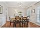 Elegant dining room with hardwood floors, wainscoting, and modern light fixture at 175 Turnberry Ln, Mooresville, NC 28117