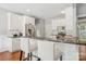 Bright kitchen features white cabinets, stainless steel appliances, hardwood floors and dark granite countertops at 175 Turnberry Ln, Mooresville, NC 28117