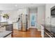 Spacious kitchen with stainless steel refrigerator, hardwood floors, and white cabinets at 175 Turnberry Ln, Mooresville, NC 28117