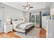Inviting main bedroom with tray ceiling, ceiling fan, hardwood floors and bright window at 175 Turnberry Ln, Mooresville, NC 28117