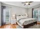 Relaxing main bedroom features hardwood floors, a ceiling fan, bright windows and a cozy rug at 175 Turnberry Ln, Mooresville, NC 28117