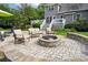 Backyard patio featuring a stone fire pit and ample seating, perfect for entertaining guests at 175 Turnberry Ln, Mooresville, NC 28117