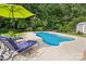 Inviting in-ground pool with patio, lounge chairs, and a verdant backyard, perfect for outdoor relaxation at 175 Turnberry Ln, Mooresville, NC 28117