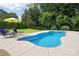 Backyard featuring a private pool with a concrete deck and mature landscaping at 175 Turnberry Ln, Mooresville, NC 28117