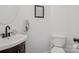 Elegant powder room with vessel sink, dark vanity, and decorative wall art at 175 Turnberry Ln, Mooresville, NC 28117