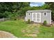 Outdoor shed nestled in a well-maintained backyard with stepping stones and tasteful landscaping at 175 Turnberry Ln, Mooresville, NC 28117