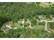 Overhead view of homes nestled amongst green trees, connected by quiet roads for serene community living at 176 Sharon Valley Dr, Hickory, NC 28601
