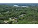 Expansive aerial view showcasing the lush, tree-lined neighborhood near the tranquil lake and distant bridge at 176 Sharon Valley Dr, Hickory, NC 28601