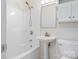 Bright bathroom featuring a pedestal sink, shower, toilet, and mirrored medicine cabinet at 176 Sharon Valley Dr, Hickory, NC 28601