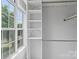 Well-organized closet with built-in shelving and ample storage, complemented by natural light from the window at 176 Sharon Valley Dr, Hickory, NC 28601