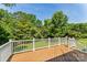 Private wooden deck overlooking a lush backyard with mature trees, perfect for outdoor relaxation at 176 Sharon Valley Dr, Hickory, NC 28601