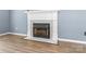 Close-up of a modern fireplace with a white mantle, tile surround, and a wood-burning insert at 176 Sharon Valley Dr, Hickory, NC 28601