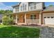 Welcoming front porch with brick accents and white railings offering curb appeal and a charming entrance at 176 Sharon Valley Dr, Hickory, NC 28601