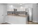 Updated kitchen features white cabinets, stainless steel appliances, granite countertops, and decorative tile backsplash at 176 Sharon Valley Dr, Hickory, NC 28601