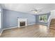 Bright living room with a fireplace, wood floors, a ceiling fan, and neutral-colored walls at 176 Sharon Valley Dr, Hickory, NC 28601