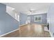 Open-concept living room with wood floors, stairs, a fireplace, and abundant natural light at 176 Sharon Valley Dr, Hickory, NC 28601
