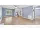 Inviting living room with light blue walls, wood floors, a ceiling fan, and a staircase at 176 Sharon Valley Dr, Hickory, NC 28601
