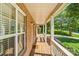 Covered front porch showcasing brick exterior with white columns and a wooden floor at 176 Sharon Valley Dr, Hickory, NC 28601