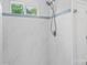Updated shower featuring white tiling with decorative blue tile border at 176 Sharon Valley Dr, Hickory, NC 28601