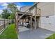 Backyard area featuring outdoor seating with built-in bar under a deck, grill, and nice lawn at 1826 Hall Ave, Charlotte, NC 28205