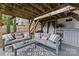 Backyard area under a deck featuring comfortable seating, a built-in bar, and string lights at 1826 Hall Ave, Charlotte, NC 28205