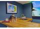 Finished basement bar area with a wooden bar and entertainment center featuring an ocean scene at 1826 Hall Ave, Charlotte, NC 28205