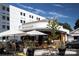 Milkbread's inviting storefront with a striped awning, outdoor seating, and stylish design at 1826 Hall Ave, Charlotte, NC 28205