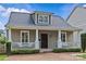 Charming front exterior of a home with inviting porch, brick pathway, and well-maintained landscaping at 1826 Hall Ave, Charlotte, NC 28205