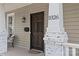 Inviting front porch featuring a dark wood door with decorative columns and visible house number at 1826 Hall Ave, Charlotte, NC 28205